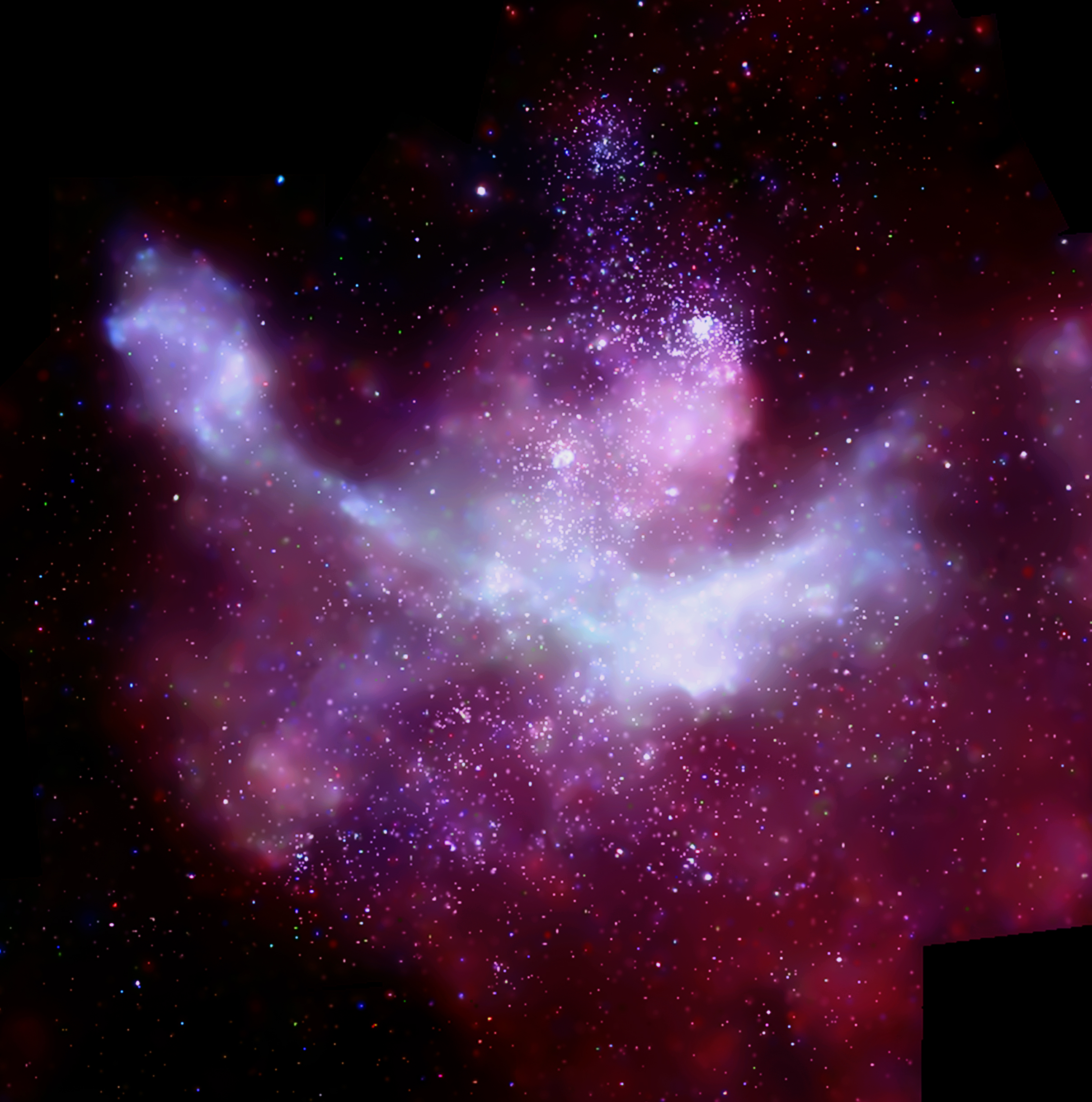 An astronomical image showing reddish-purple clouds with thousands of individual points of light. 